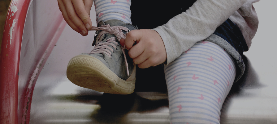 Enfant qui s'attache les lacets